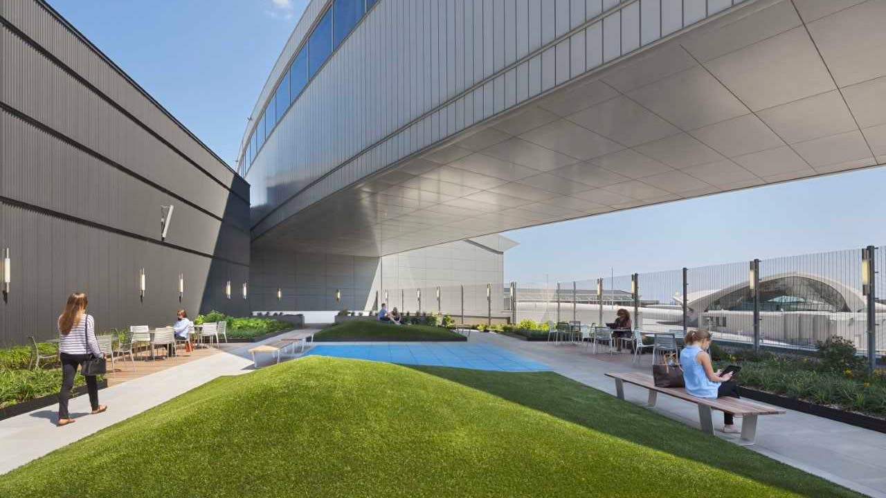 Terminal 5 Skywalk with outdoor seating and grassy area